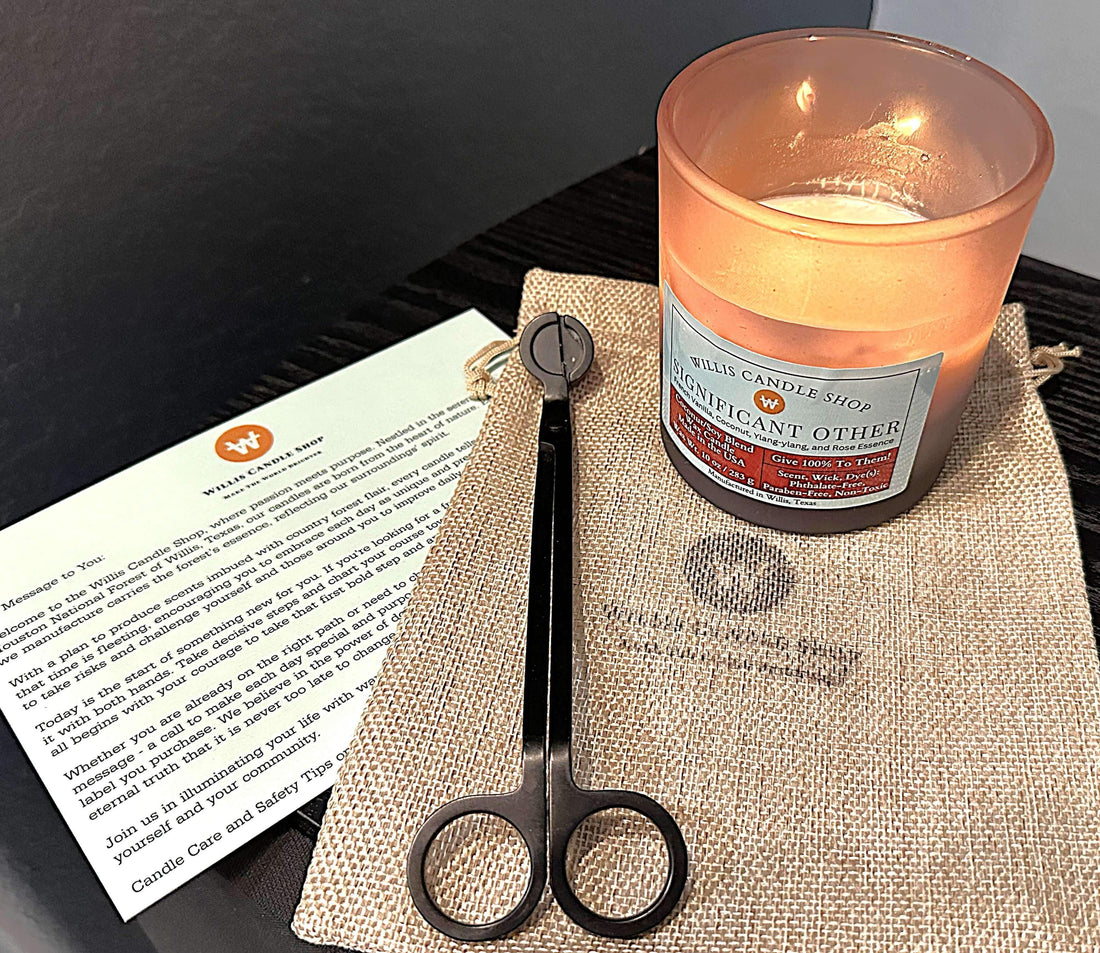 Scented candle burning next to candle care instruction card.