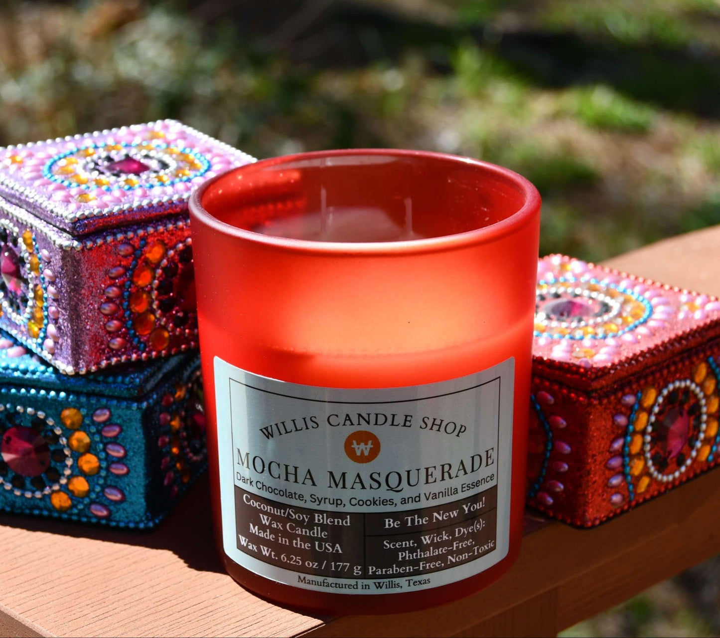 Red frosted glass scented candle in Mocha Masquerade scent.