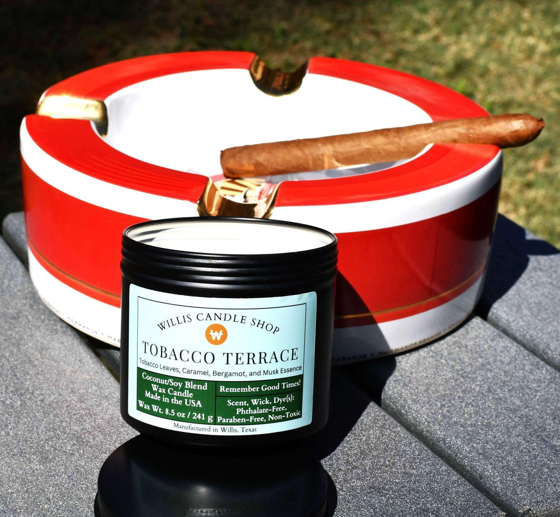 Tobacco Candle next to cigar on table outdoors.