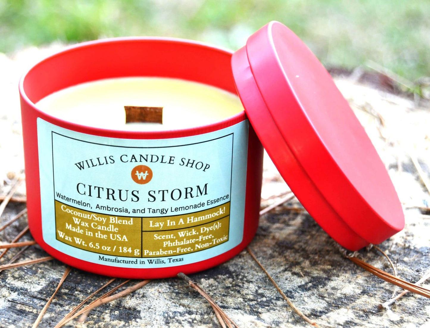 Citrus Storm scented candle option in red tin and wood wick candle at Willis Candle Shop.
