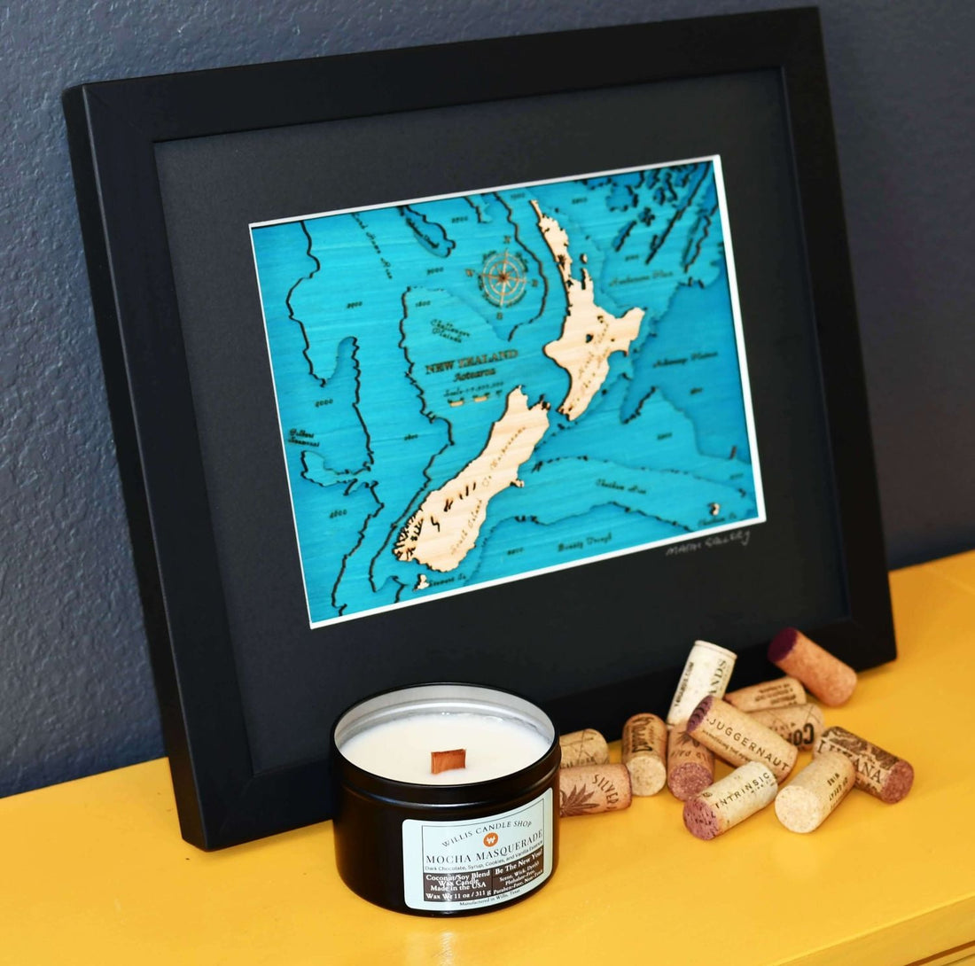 Black tin candle with corks and a picture on a sofa table.