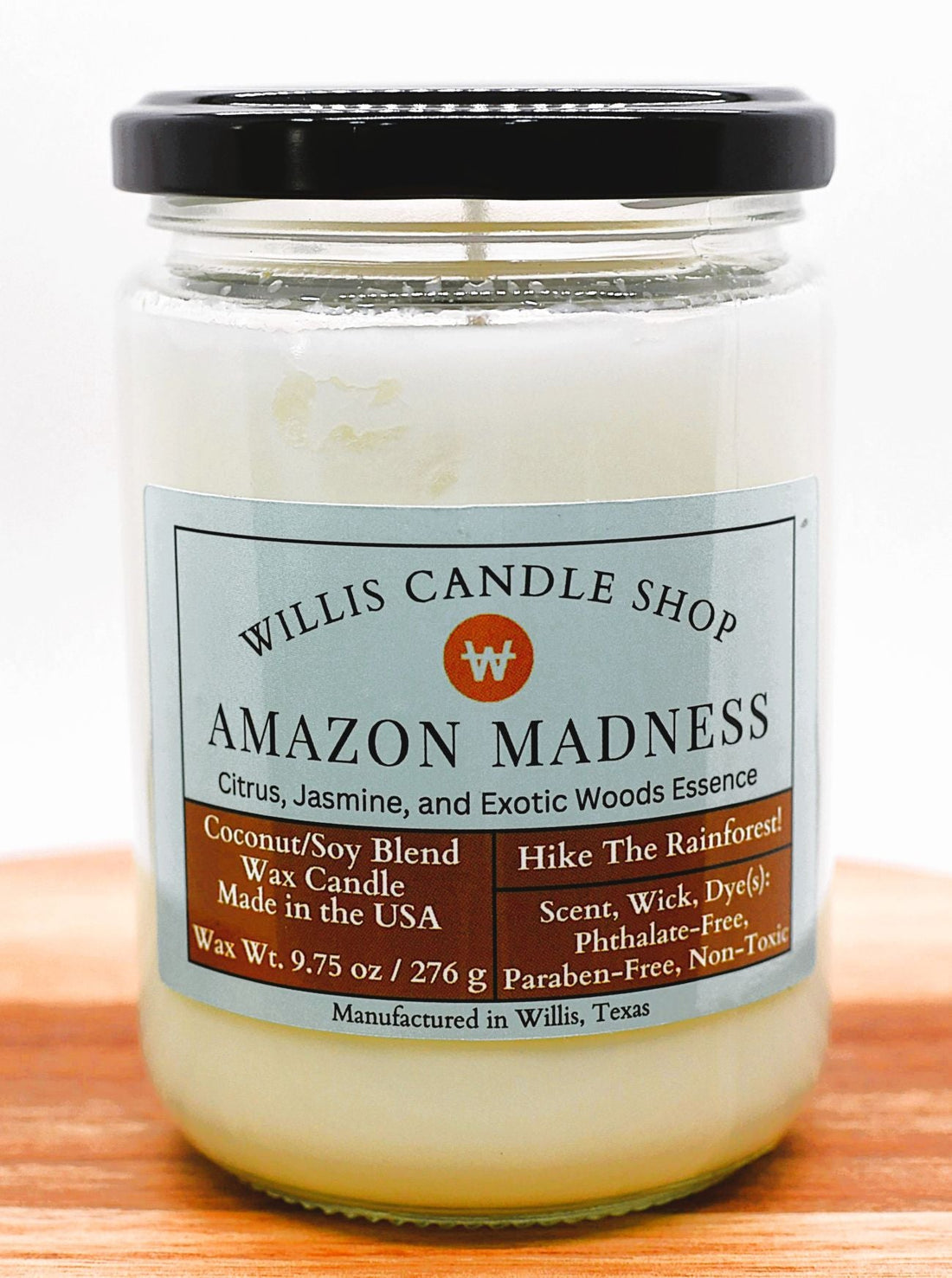Amazon Madness scent in a glass jar candle with black lid.