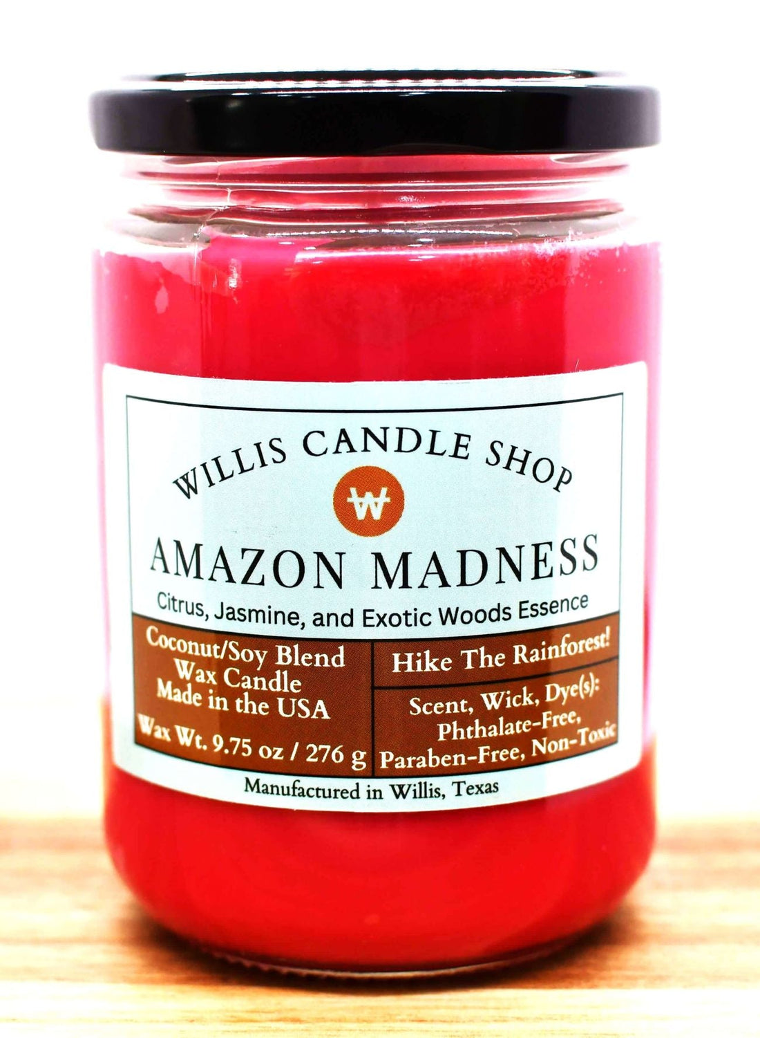 Red wax glass candle with black screw on lid and Amazon Madness scent.