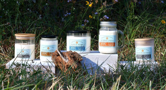 scented candles on a platform in grass.