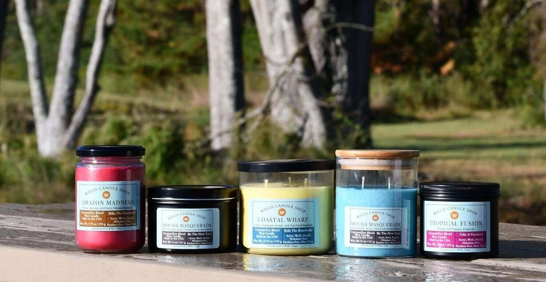 Scented candle collection on table in forest of Willis Candle Shop.