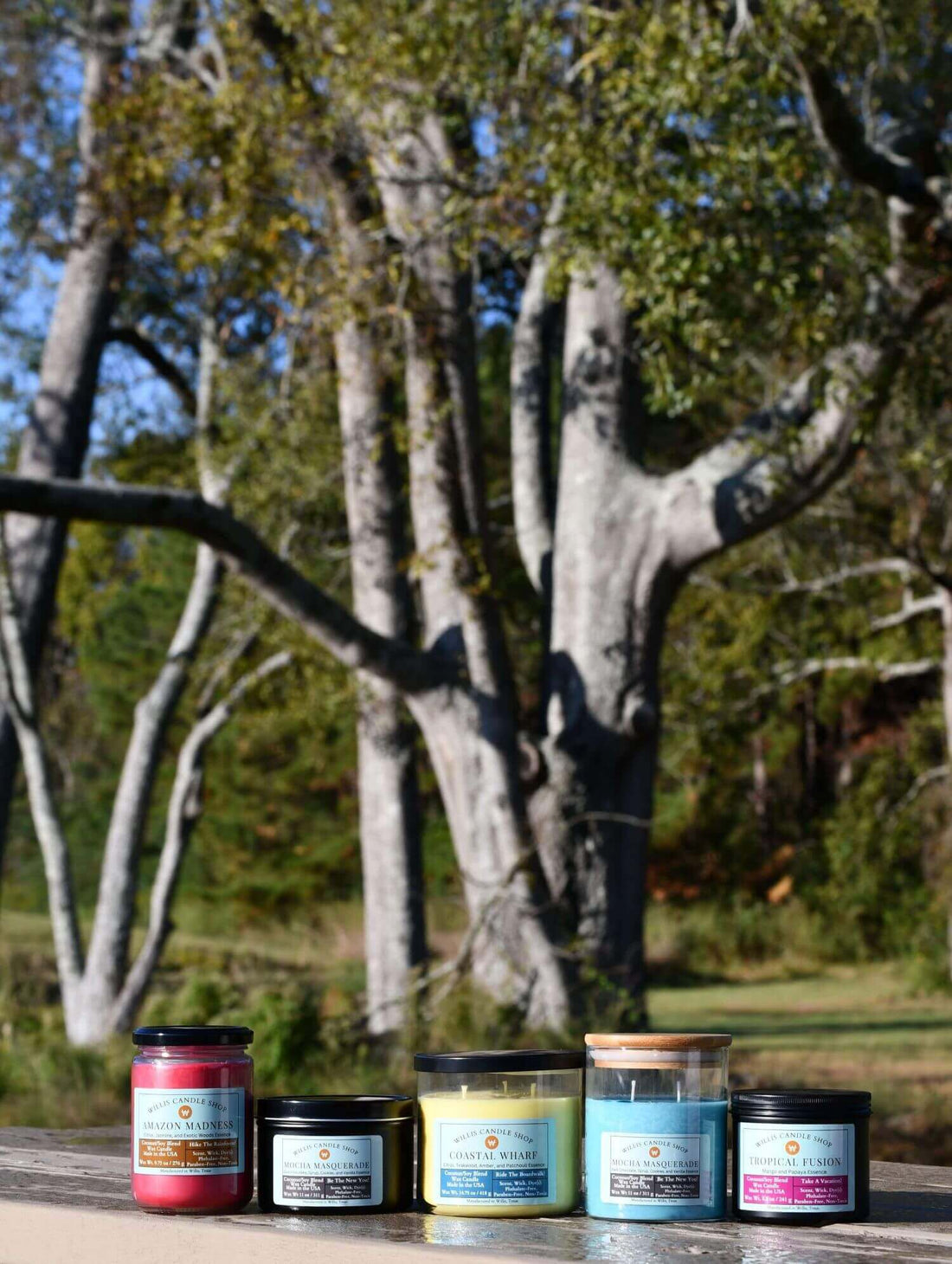 Scented candles staged on a picnic table at a pond in Willis, Texas.