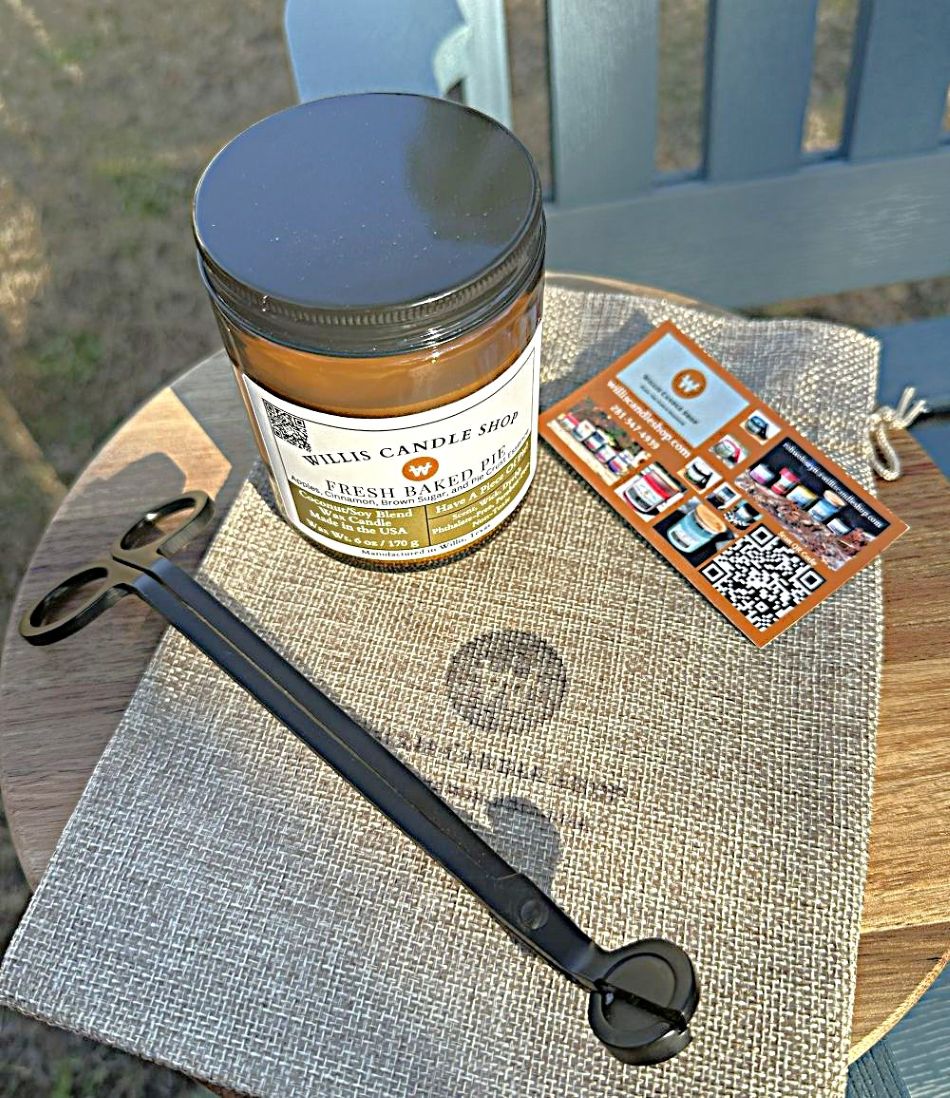 Amber glass candle with wick trimmers and burlap bag.