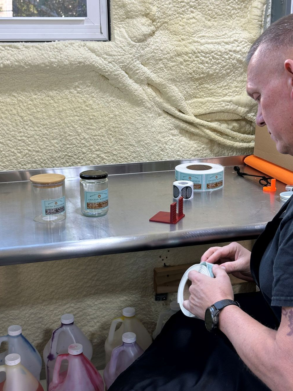 Labeling scented candles at the Willis Candle Shop.