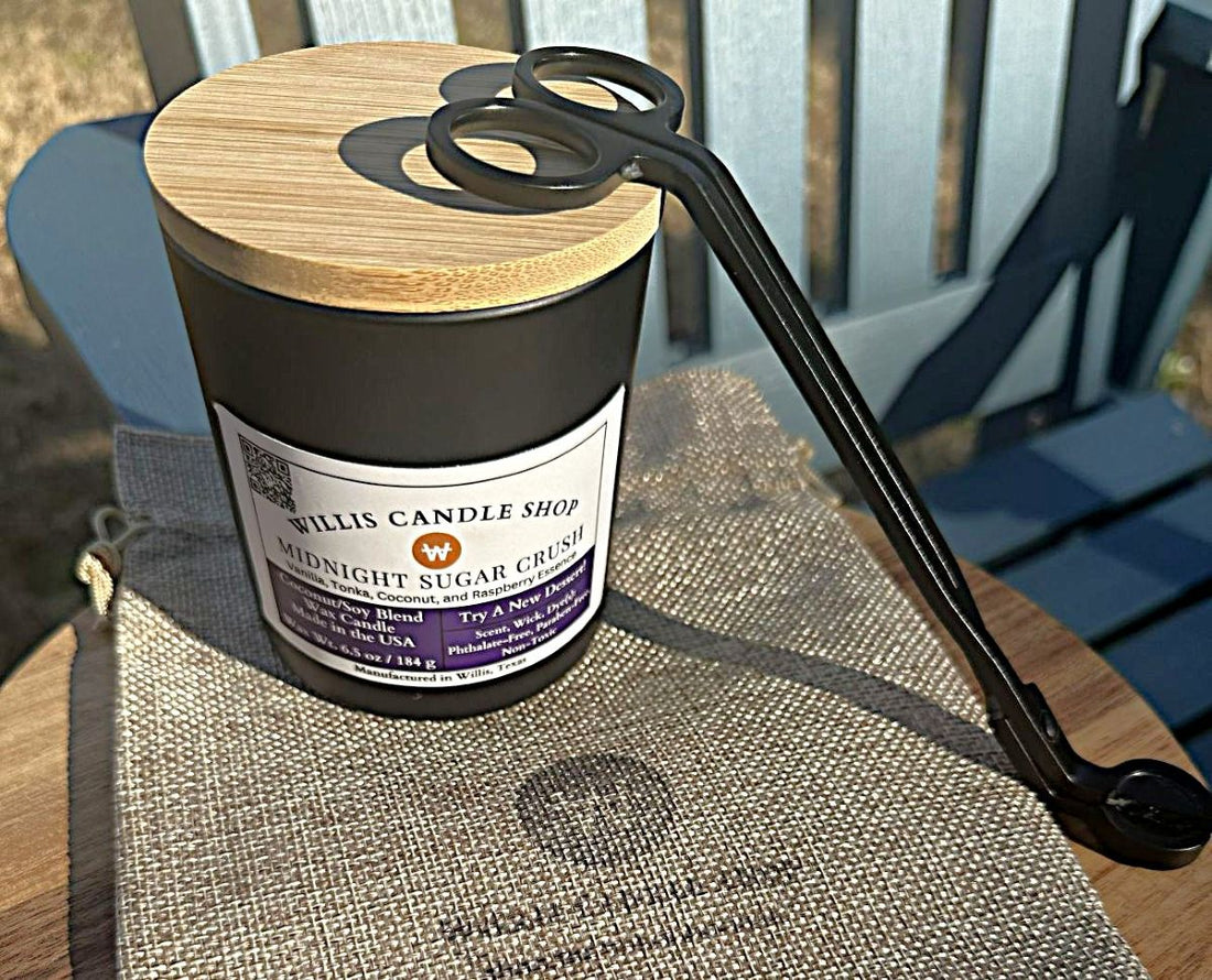 Black candle container with wick trimmers and burlap bag outdoors in Willis, Texas.