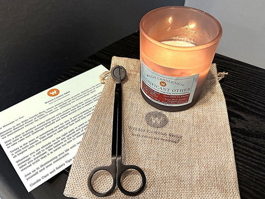 Black frosted glass candle with wick trimmers and candle care card.