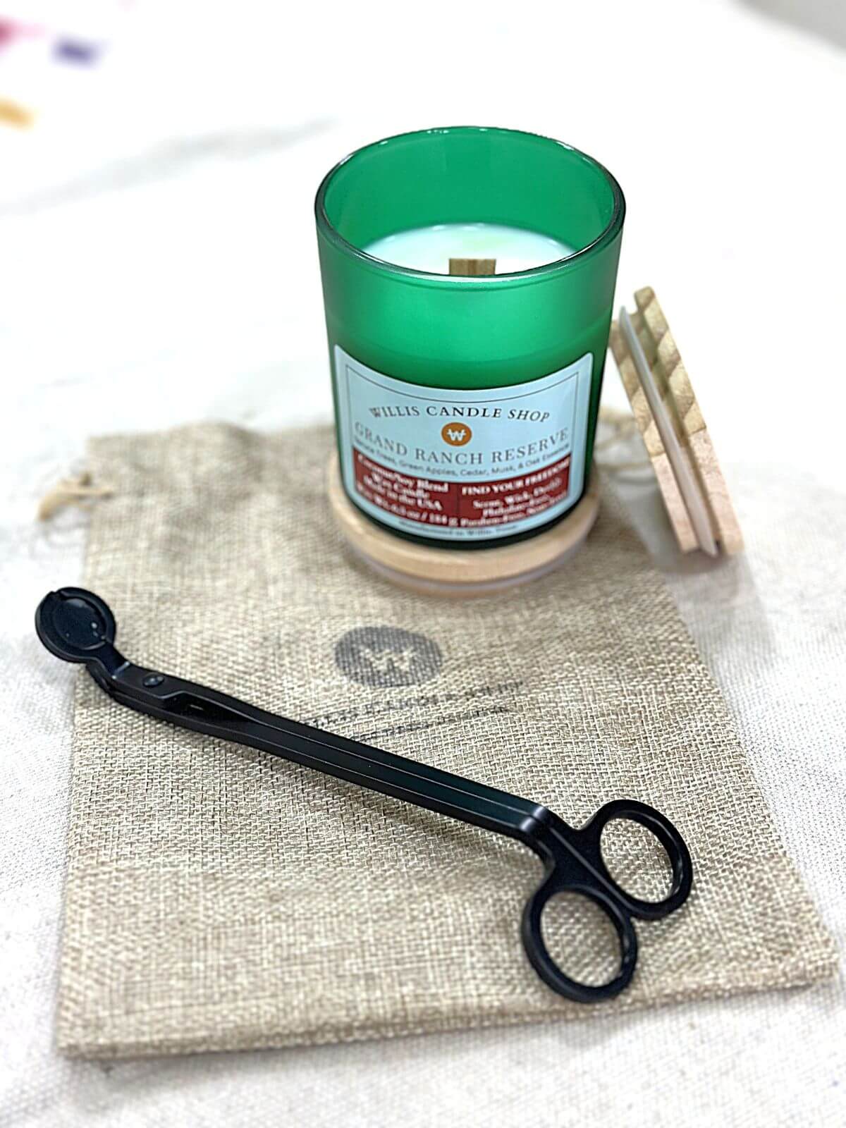 Grand Ranch Reserve scented candle on burlap bag at the Willis Candle Shop.