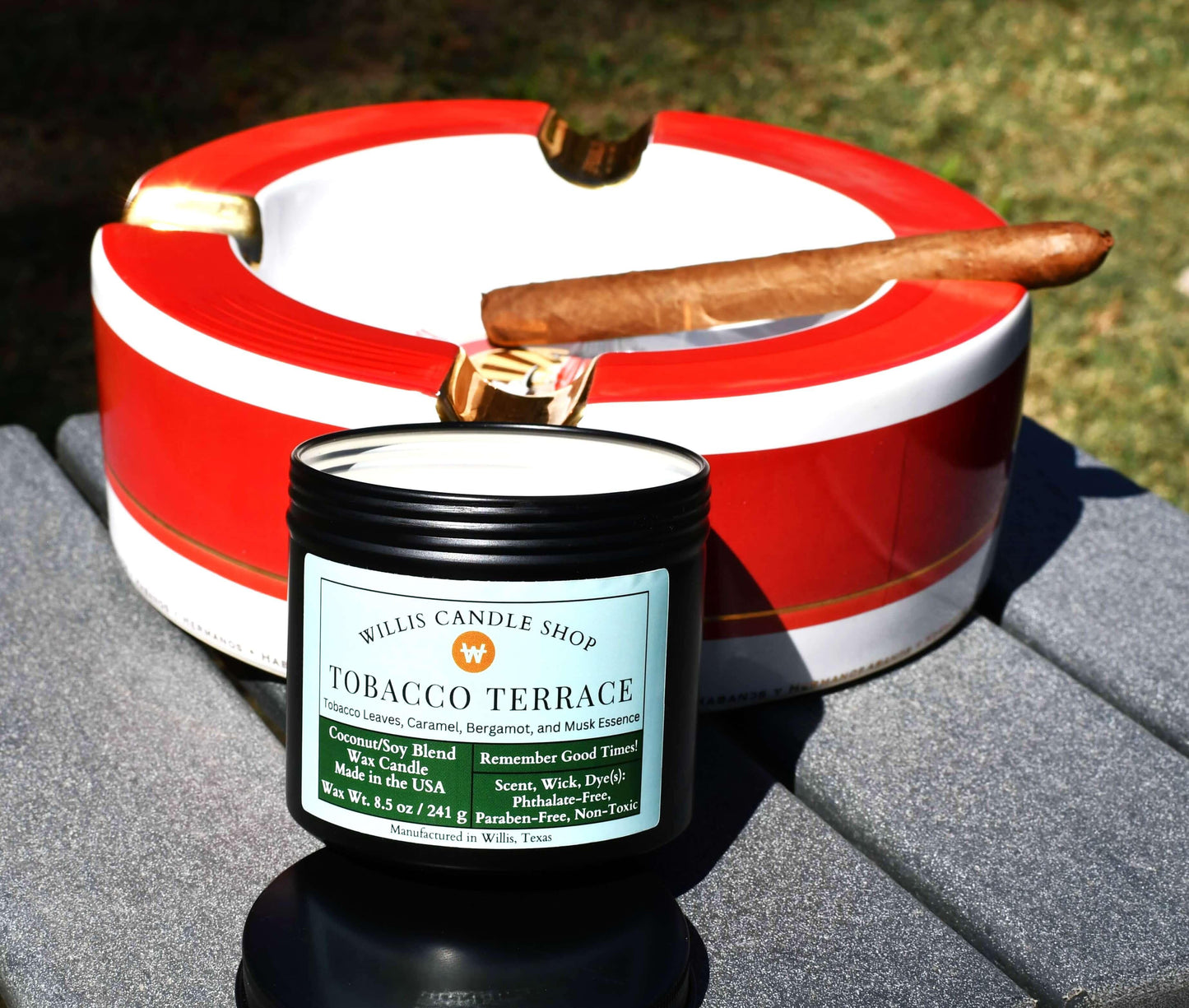 Tobacco candle on table with ashtray and cigar.