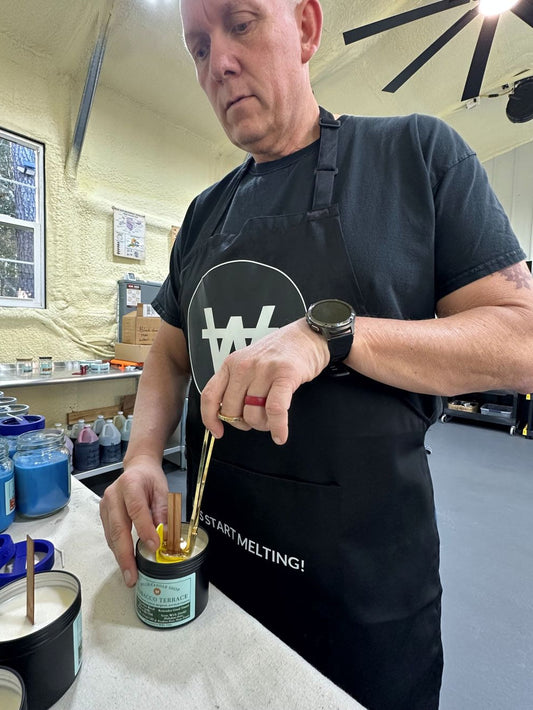 Trimming wicks at the Willis Candle Shop with the Tobacco Candle.