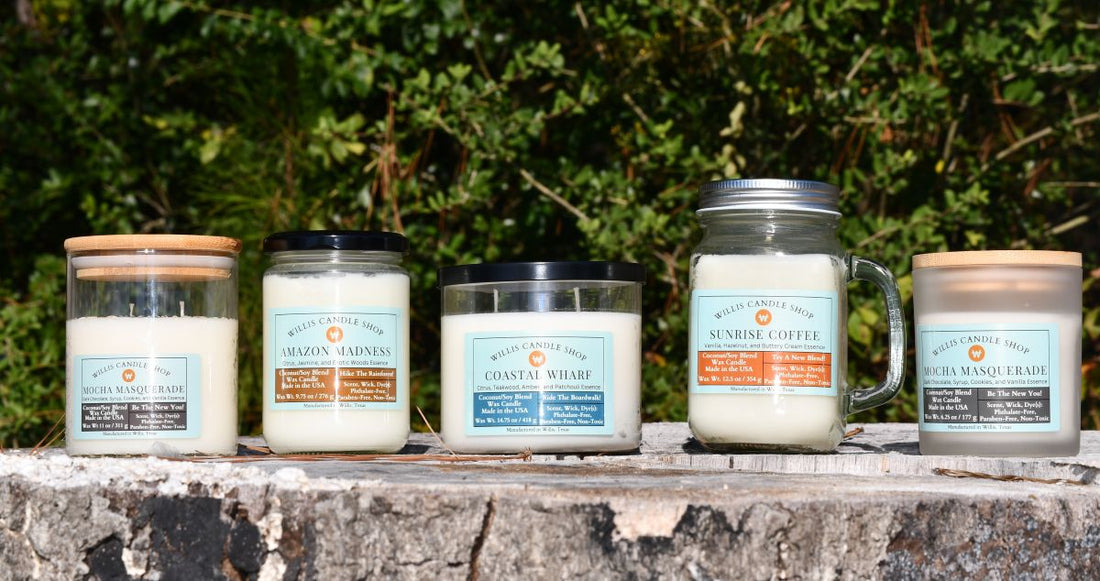 Scented candle collection with white wax candle option on a tree stump in Willis, Texas.