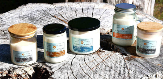 Luxury candle collection on a tree stump by pond in Willis, Texas.