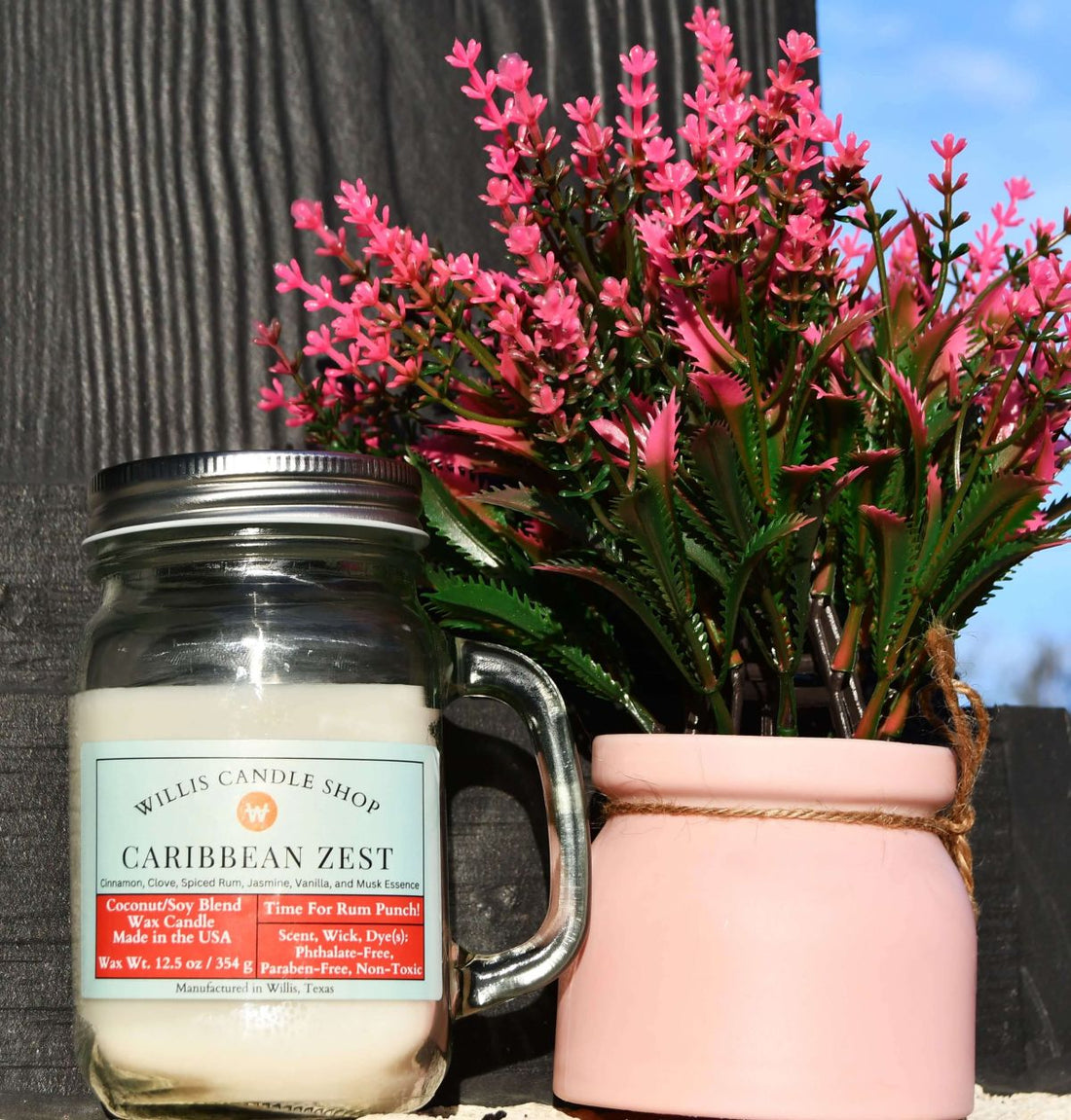 Vanilla candle on front porch with flowers at Willis Candle Shop.