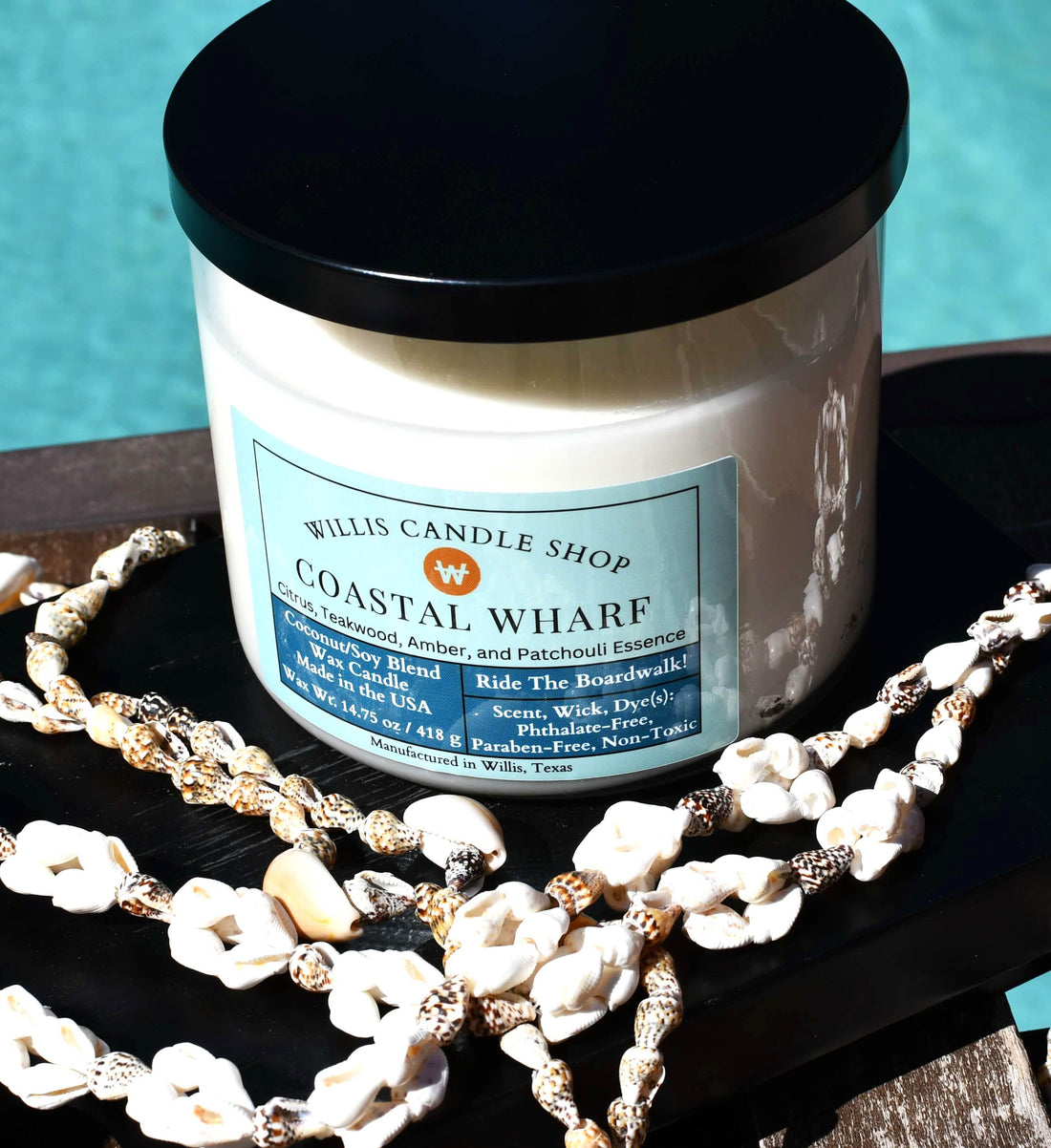 3 wick candle with white wax in clear glass candle container.
