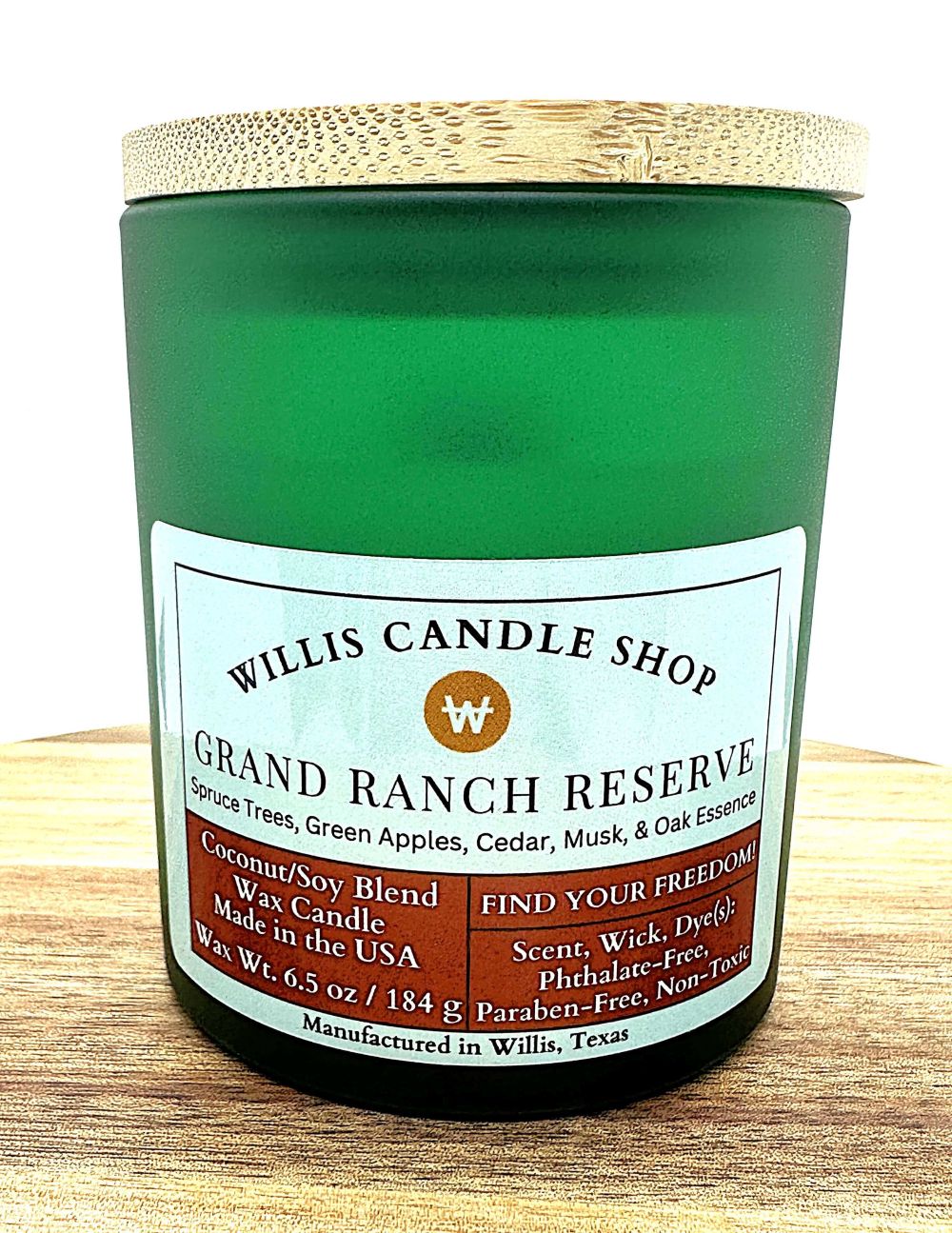 Grand Ranch Reserve candle with bamboo lid and frosted green vessel.