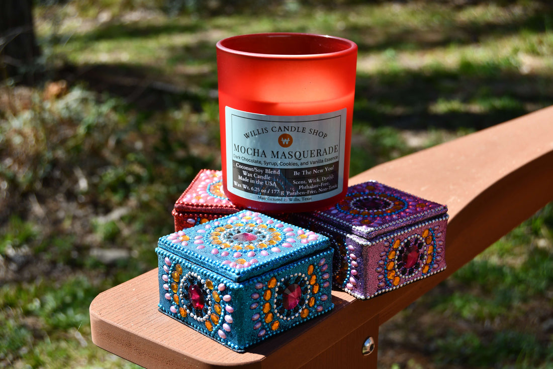Red frosted glass candle with knick-knacks on an arm chair.