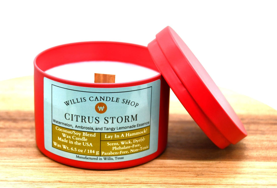 A photo of red tin candle citrus storm scent.jpg featuring our coconut, soy, beeswax matrix candle made at the Willis Candle Shop in Willis, Texas.