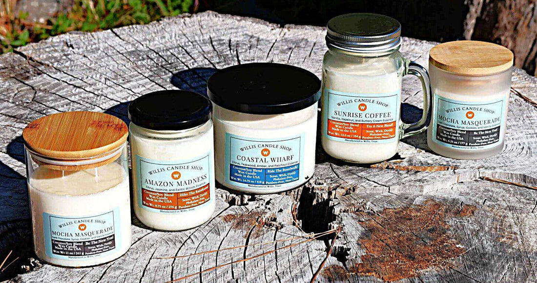 Scented candle collection with white wax candles staged on a tree stump in Willis, Texas.