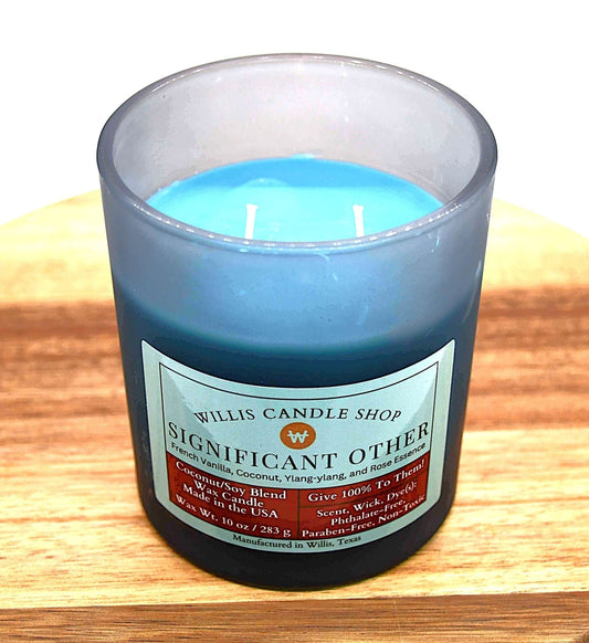 Double wick candle with sea green was and a black frosted candle container.