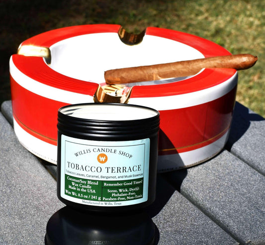 Tobacco Candle next to cigar on table outdoors.