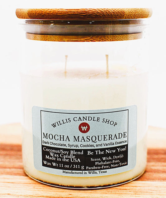 Candle with a wooden lid labeled 'Willis Candle Shop Mocha Masquerade' on a wooden surface.