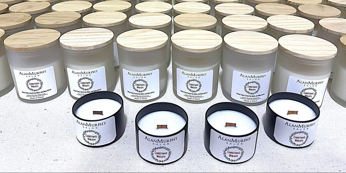 Multiple custom candles with visible labels on a light background for the Alan Murphy Salon.