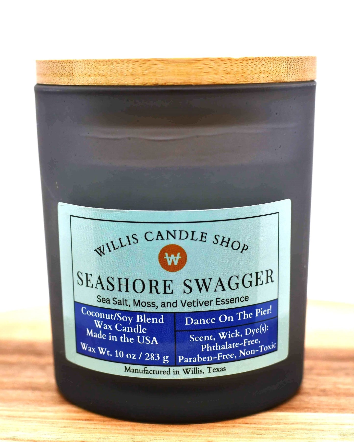 White coconut and soy 25/75 blended candle in a black-frosted container with sea salt, moss, and vetiver essence.