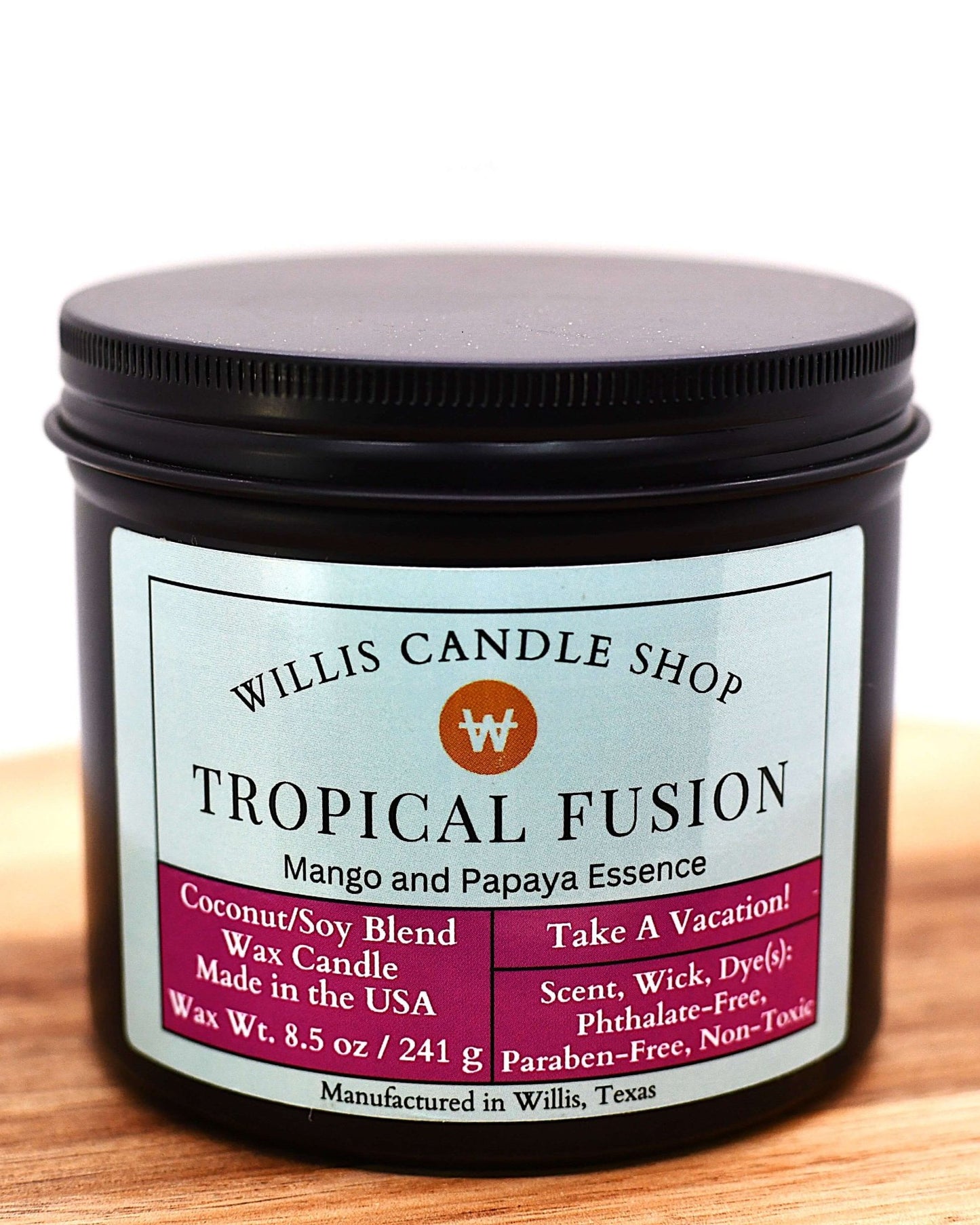 Coconut and soy 25/75 blended candle in a 10 ounce black tin with mango and papaya Tropical Fusion fragrance.