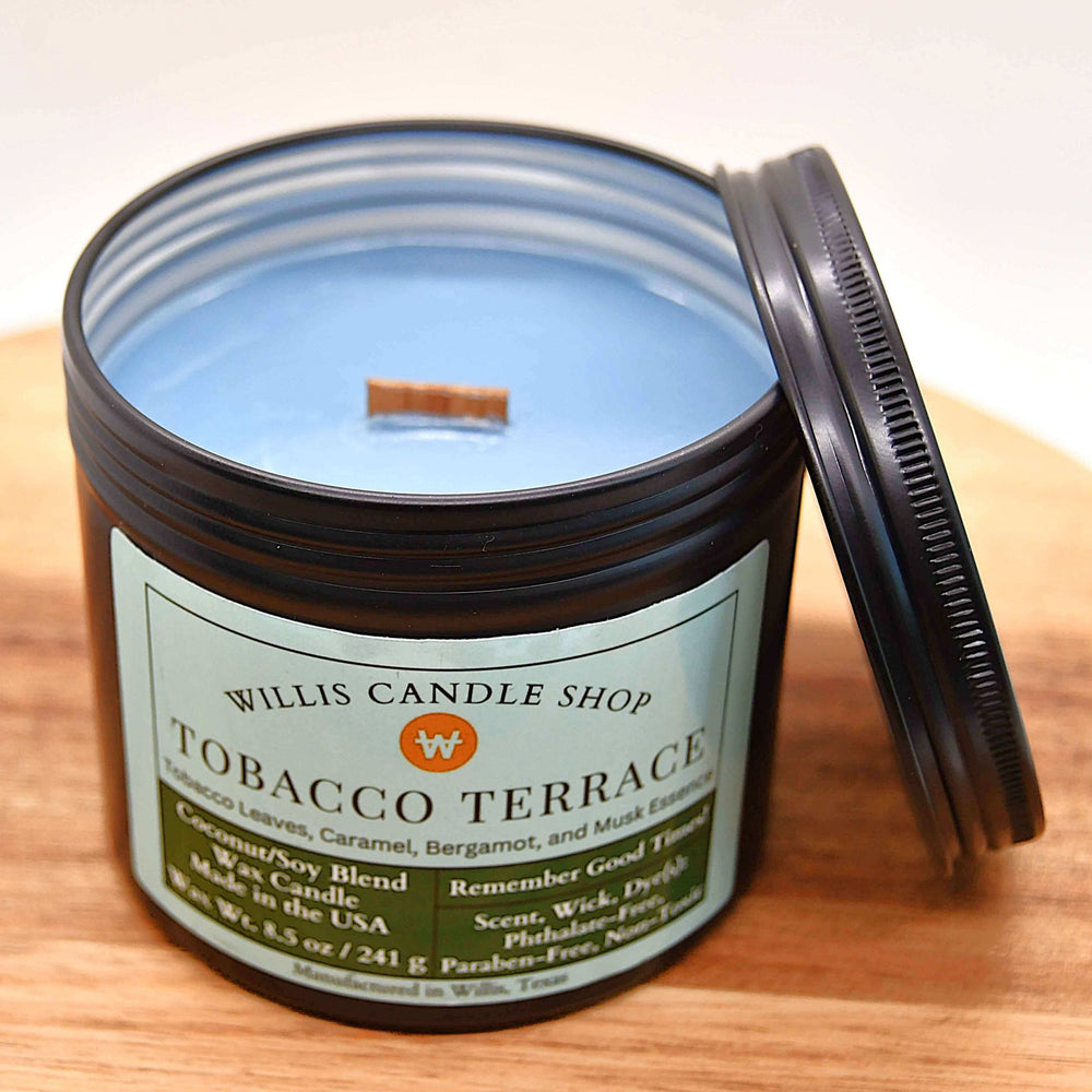 
                  
                    8.5 oz slate blue coconut-soy wax candle with Tobacco Terrace scent in a black tin container, eco-conscious and hand-crafted
                  
                