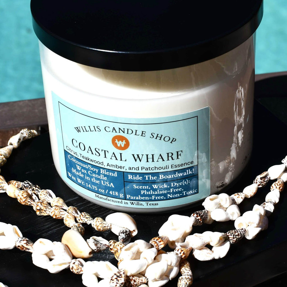 
                  
                    White coconut and soy 25/75 blended candle in a glass container with black lid and Coastal Wharf fragrance.
                  
                