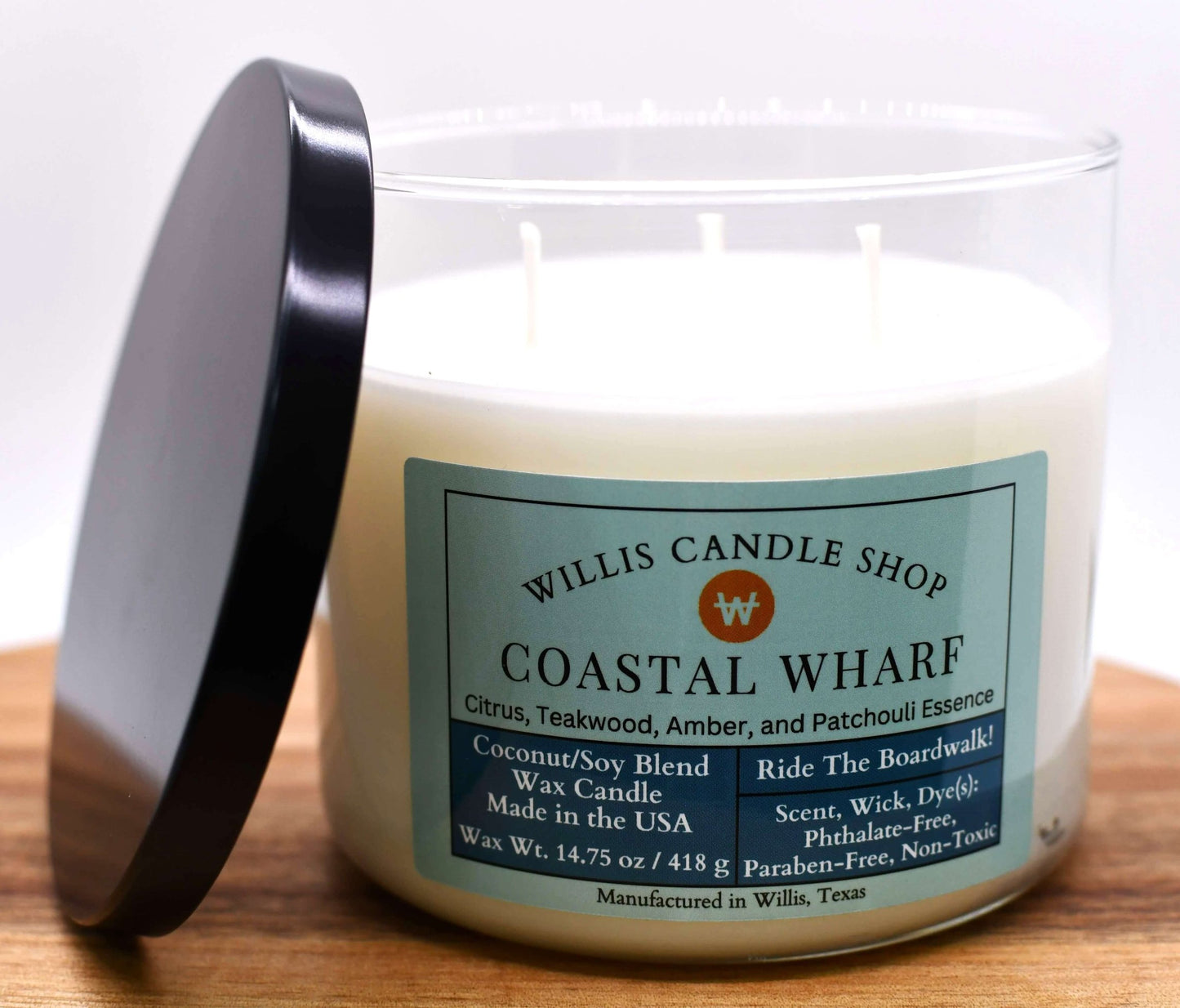 White coconut and soy 25/75 blended candle with Coastal Wharf fragrance in a 21 ounce Contempo glass container.