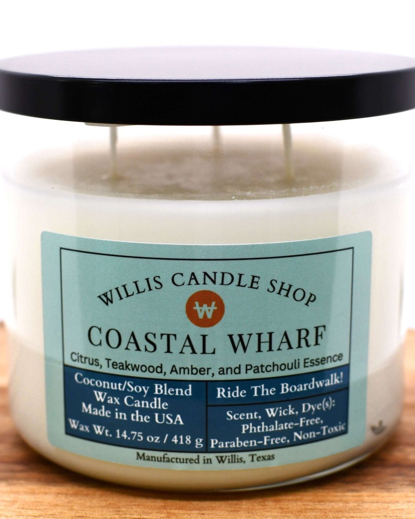 White coconut and soy 25/75 blended candle in a 21 ounce glass container with citrus, teakwood, amber, and patchouli scent.