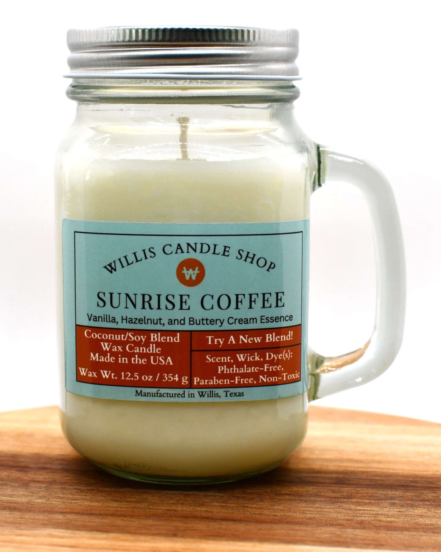 White coconut and soy 25/75 blended candle in a glass mug with Sunrise Coffee fragrance.