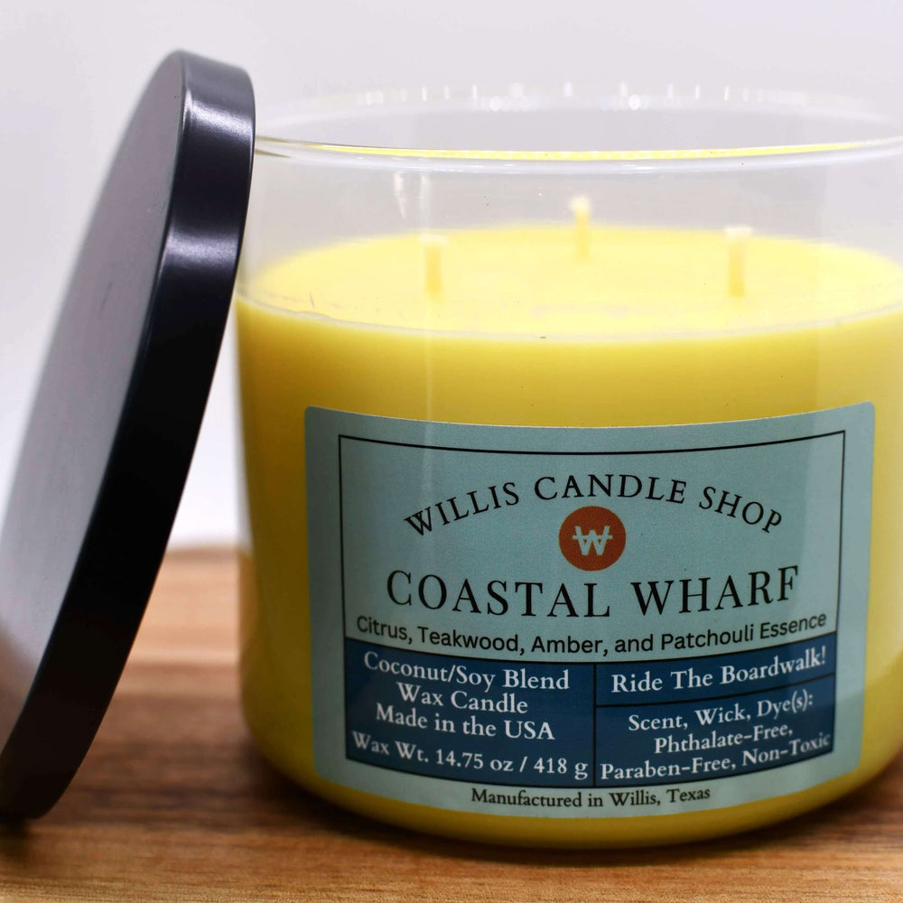 Yellow coconut and soy 25/75 blended candle in a jumbo glass container with black lid and Coastal Wharf fragrance.